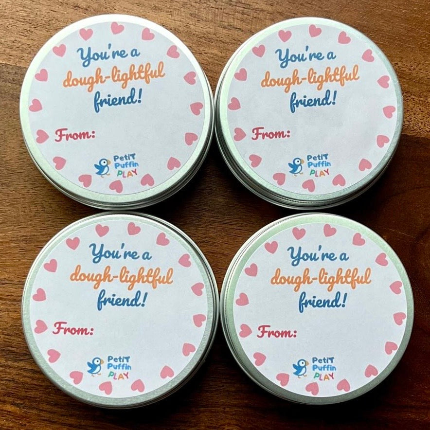 4 small tins of play dough with labels intended for gifting